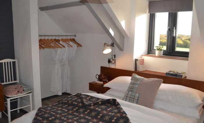 Bright double bedroom with countryside views.